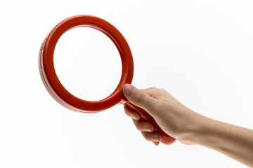 Isolated red Plastic Toy Magnifying Glass for Exploring and Catching Bugs on White Background.