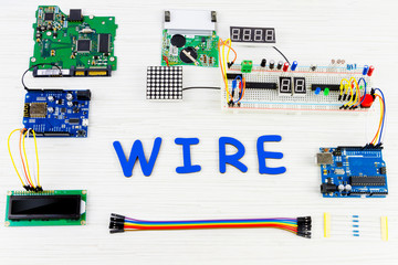 Microcontrollers, chips, resistors and light-emitting diodes on white desktop of hardware engineer....