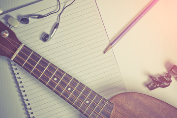 concept song composer:Notebook and pencil ,Ukulele ,style vintage