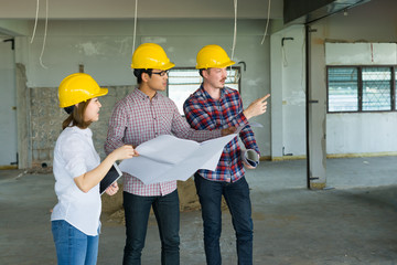 Engineer group and worker meeting, discussion with construction blueprint on site work