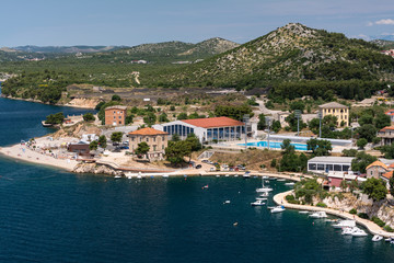 Fototapeta na wymiar Panoramic view on mediterranean town of Sibenik, Croatia from the top of mountain, sea bay on background.