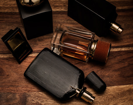 different bottles of perfume in wooden background