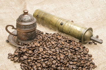 Coffee grinder, cup and coffee seeds
