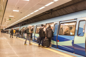 subway train station platform with people traveling