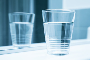 Glass of water stand, blue toned filter