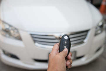 A hand press button of remote control car key to opens a car door.