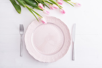 Top view of pink plate and tulips above