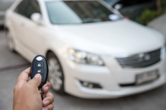 A hand press button of remote control car key to opens a car door.