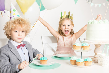 Children sitting at birthday table