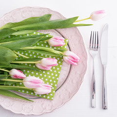 Top view on pink tulips on pink plate