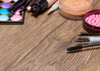 Obraz na płótnie Canvas Frame of basic makeup products on wooden surface