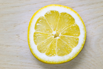 Slice of lemon on wooden table