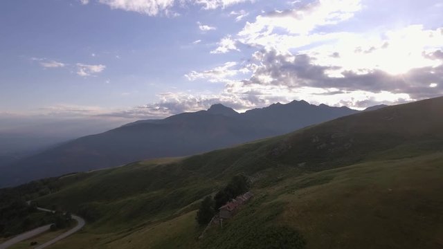 bald mountain in summer sunny sunset or sunrise dawn or dusk with road and lodge 4k aerial drone forward flight wide establishing shot 