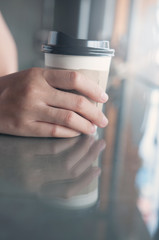 Close up of woman hand holding cup of coffee.