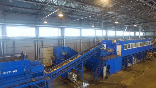 Conveyor at a recycling plant. Wide angle shot. 4K.