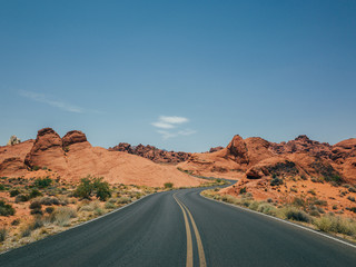 A winding road carved in the red rock in the valley of fire national park
