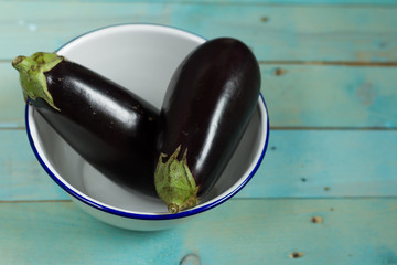 Eggplants on wooden, blue table. Close up.