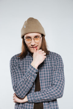 Vertical image of Pensive hipster in eyeglasses