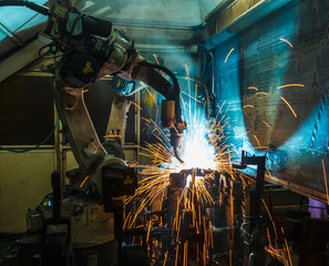  Welding robots in a car factory with sparks, manufacturing, industry