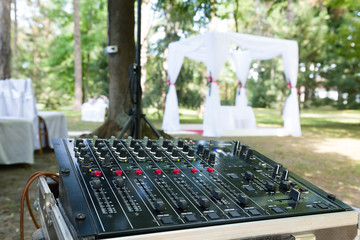 audio mixer in wedding ceremony in forest in summer