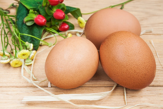 Easter is comming! Close up image of fresh eggs on wooden background.