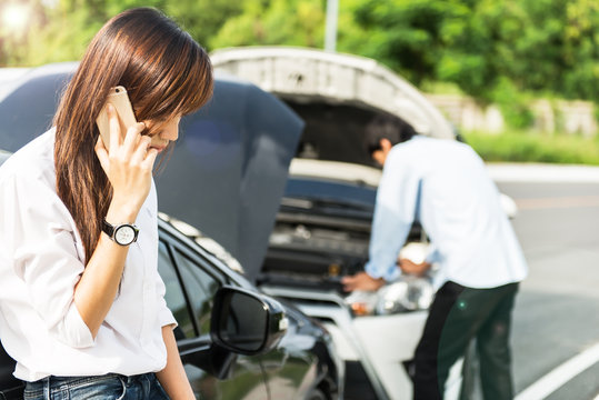 Car Collision. Driver Man And Woman Examining Damaged Automobile Cars After Crash Accident In City