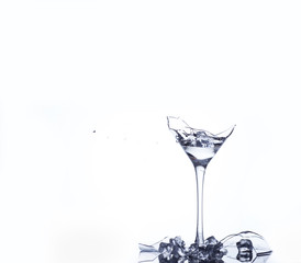 Water splash in a broken goblet. Water drops in a glass. Shattered goblet