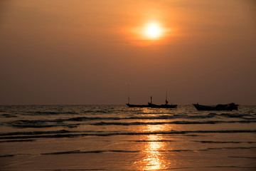 Fototapeta na wymiar Silhouette fisherman's boats in the sea on sunset background