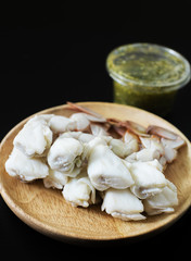 steamed crab legs with spicy sauce dip on black background, thai style, seafood