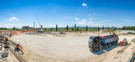 Works in progress on costruction site, panoramic view