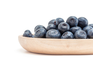 blueberry fruit in wooden plate isolated on white background