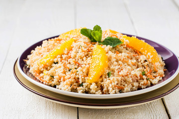 Salad of crumbly couscous with carrots, orange and mint