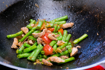 fried pork with cowpea in a pan