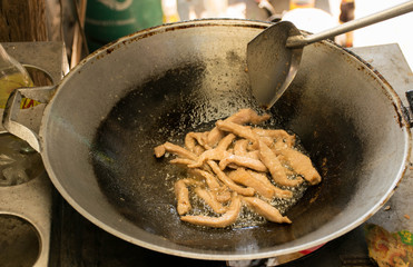 fried pork in a pan, delicious food