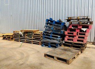 old pallet in front of metal wall for background