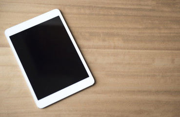 Electronic tablet on a wooden background 