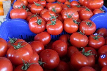 red tomatos for sale at a bazaar