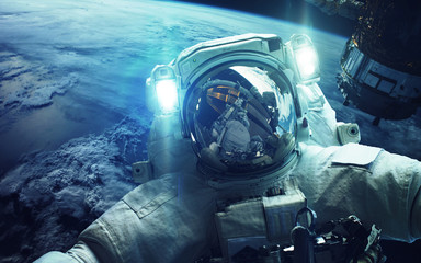 Astronaut in outer space. Elements of this image furnished by NASA