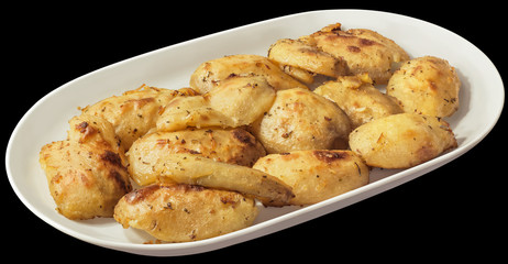 Baked Seasoned Potato Halves in Oblong White Porcelain Platter Isolated on Black Background