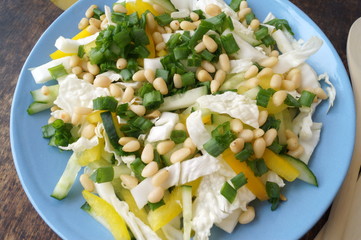 Organic, vegetarian salad from fresh vegetables with pine nuts