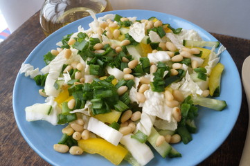 Organic, vegetarian salad from fresh vegetables with pine nuts