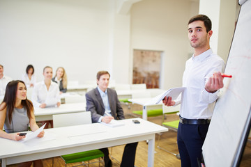 Young man in a seminar with a flipchart