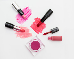 Makeup blush and lipsticks on white background