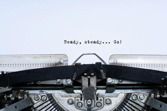 ready. steady. go. slogan taped words on a vintage typewriter