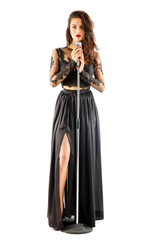 Full-length shot of a pretty woman singing into the microphone on white isolate. Set of well-chosen dress and accessories