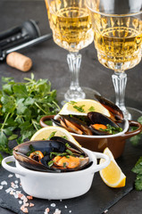 Mussels in wine with parsley and lemon. Seafood. Clams in the shells. Delicious snack for gourmands. Selective focus