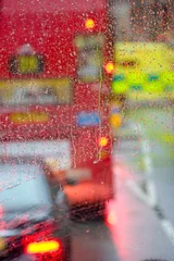 Fotobehang Rain in London view to red bus through rain-specked window © Raimond Klavins