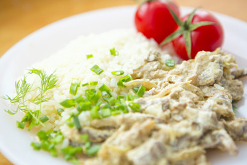 Beef Stroganoff with rice, tomatoes and greens.