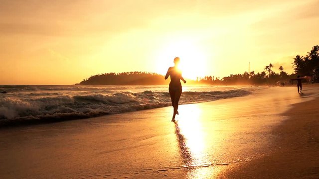 Sexy woman in bikini running on beach during sunset, super slow motion 240fps

