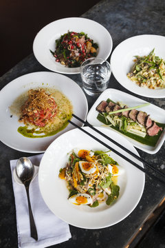 Different asian dishes at a restaurant, Candolim, Goa, India.